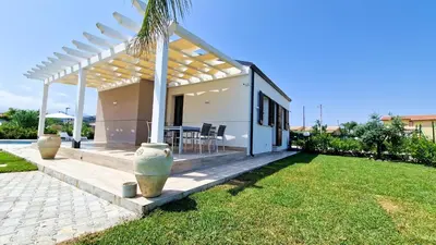 a villa with a swimming pool and a house at Villa Lilia - Private pool in Campofelice di Roccella