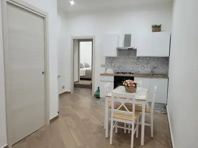 a kitchen and dining room with a table and chairs at Sweet Home Maqueda in Palermo