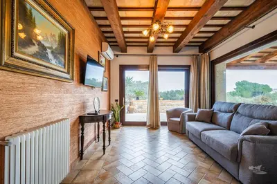 a living room with a couch and a fireplace at Villa DelMarmo in Alcamo