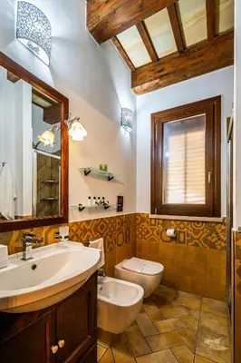 a bathroom with a sink and a toilet at Villa DelMarmo in Alcamo