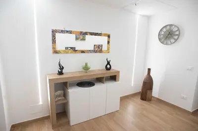 a kitchen with a table and chairs and a sink at Yris House in Palermo