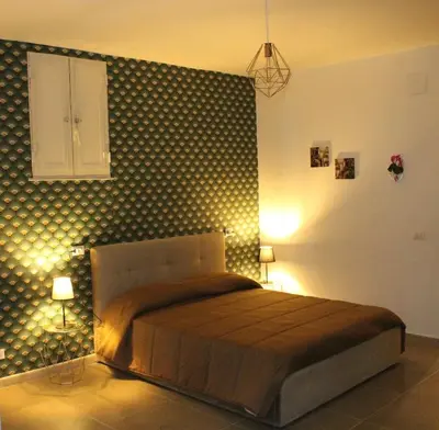 a bedroom with a bed with a polka dot wall at MARICCHIA per SAITTA HOLIDAYS in Palermo