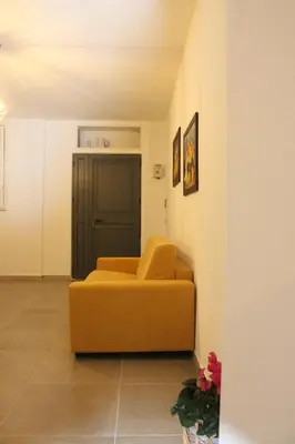 a living room with a yellow couch in a room at MARICCHIA per SAITTA HOLIDAYS in Palermo