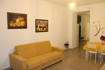 a living room with a couch and a table at MARICCHIA per SAITTA HOLIDAYS in Palermo