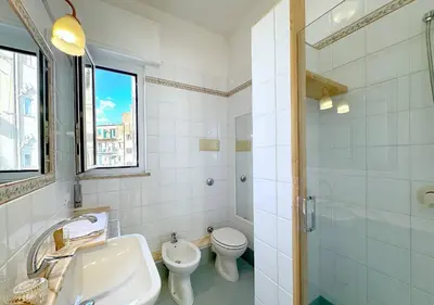 a bathroom with a sink and a toilet and a shower at Solemar Sicilia - Terrazza del Merlo in Palermo