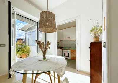 a dining room with a table and a chandelier at Solemar Sicilia - Terrazza del Merlo in Palermo