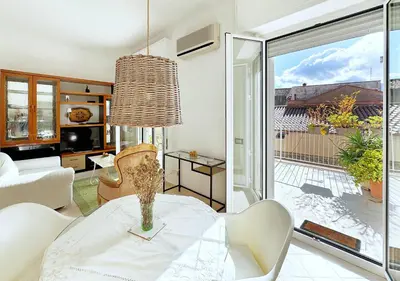 a living room with a table and a large window at Solemar Sicilia - Terrazza del Merlo in Palermo