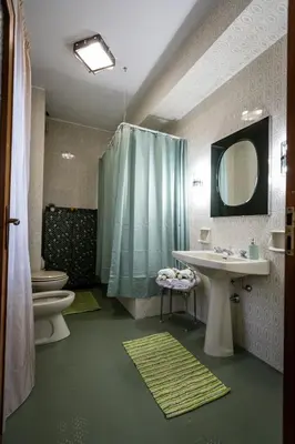 a bathroom with a shower and a sink and a toilet at Nanà Apartment in Palermo