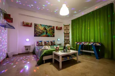 a bedroom with green curtains and a bed and a table at Nanà Apartment in Palermo