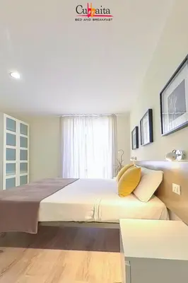 a bedroom with a large bed with yellow pillows at B&B Cubbaita in Palermo