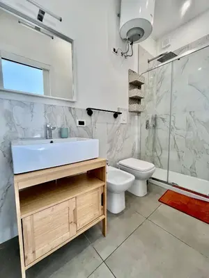 a bathroom with a sink and a toilet and a shower at Mediterranea sole in Palermo