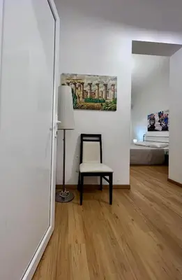 a room with a chair and a painting on the wall at Mediterranea sole in Palermo