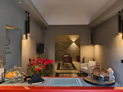 a bedroom with a large white bed with a drawing on the wall at L'Opera - Luxury Apartment in Palermo