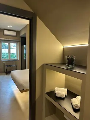 a living room with a couch and a table in a room at L'Opera - Luxury Apartment in Palermo