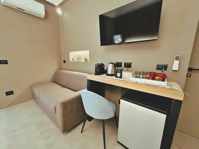 a living room with a table and a dining room at L'Opera - Luxury Apartment in Palermo