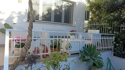 a balcony with a white railing and some plants at MONDELLO JUNO'S ROOMS in Mondello