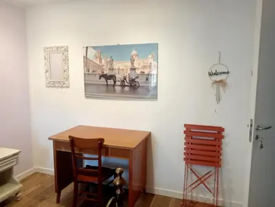 a room with a table and a picture on the wall at MONDELLO JUNO'S ROOMS in Mondello