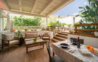 a patio with a table and chairs on a deck at Oasi Relax - Romantic Room & Spa in Torretta