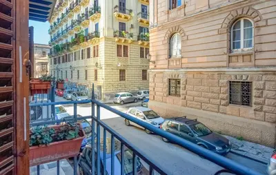 a balcony with cars parked on a city street at Gorgeous Apartment In Palermo With Wifi in Palermo