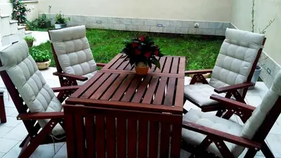 a wooden table and chairs with a plant on a patio at B&B Massimo Inn in Palermo