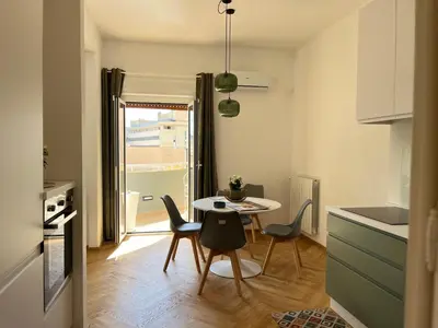 a kitchen and dining room with a table and chairs at politeama view apartment in Palermo