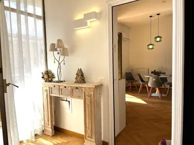 a hallway with a door leading to a dining room at politeama view apartment in Palermo