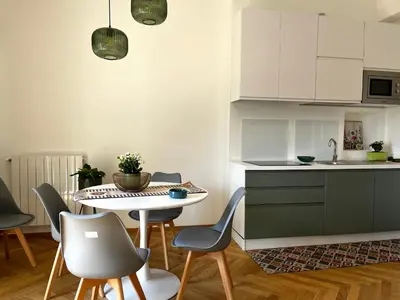 a kitchen and dining room with a table and chairs at politeama view apartment in Palermo