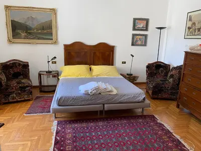 a bedroom with a bed and a rug at Da Cristina Palazzo Atanasio in Palermo