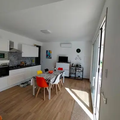 a kitchen and dining room with a table and chairs at Villa Saint George in Scopello
