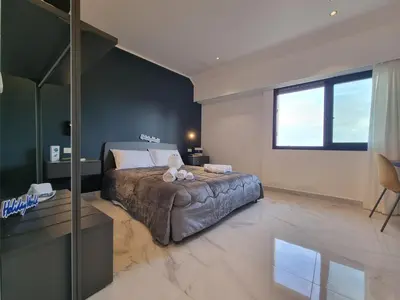 a bedroom with a bed with a teddy bear on it at MaXelA Penthouse by Holiday World in Palermo