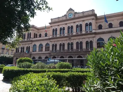 a building with a clock on the front of it at MaXelA Penthouse by Holiday World in Palermo