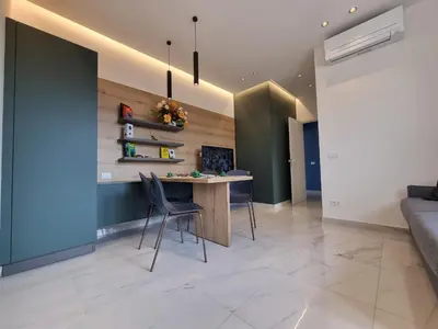 a living room with a desk and chairs at MaXelA Penthouse by Holiday World in Palermo