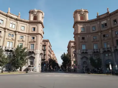 an empty street in front of two large buildings at MaXelA Penthouse by Holiday World in Palermo