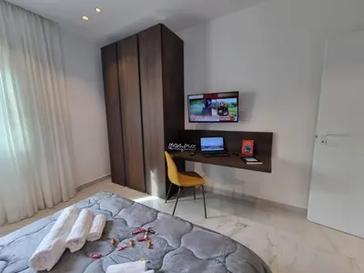 a bedroom with a bed and a desk with a computer at MaXelA Penthouse by Holiday World in Palermo