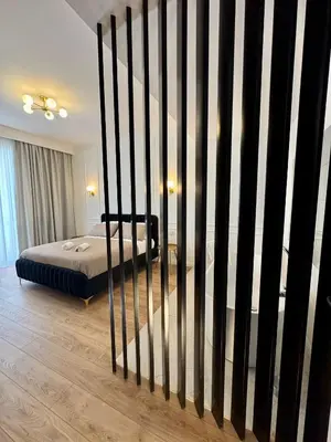 a bedroom with a bed and a black and white fence at Politeama's Home - Luxury Apartment in Palermo