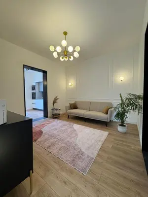 a living room with a couch and a rug at Politeama's Home - Luxury Apartment in Palermo