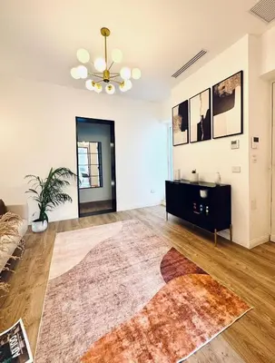 an empty living room with a couch and a rug at Politeama's Home - Luxury Apartment in Palermo