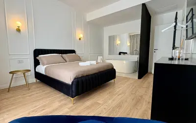 a bedroom with a bed and a bath tub at Politeama's Home - Luxury Apartment in Palermo