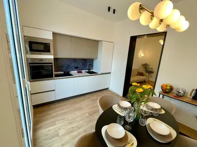a kitchen and dining room with a table and chairs at Politeama's Home - Luxury Apartment in Palermo