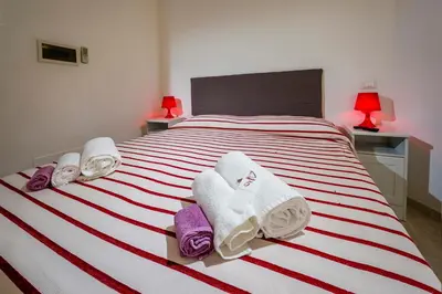 a bedroom with a bed with towels on it at Affittacamere Amunì in Castellammare del Golfo