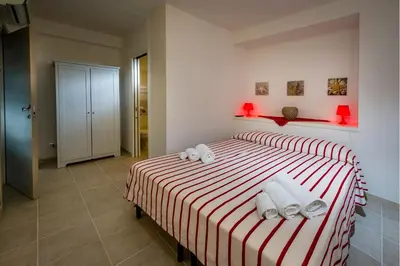 a bedroom with a bed with towels on it at Affittacamere Amunì in Castellammare del Golfo