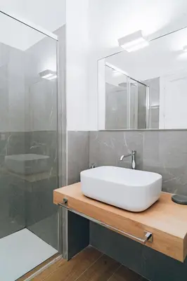 a bathroom with a white sink and a shower at Giardino del Foro in Palermo