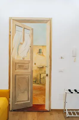an open door in a room with a painting at Giardino del Foro in Palermo