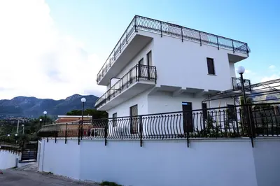 a white building with balconies on the side of it at Trabia Casa Bianca A in Mandra Capreria