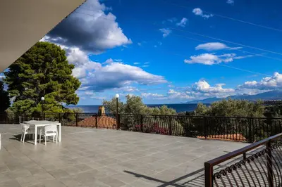 a patio with a table and chairs on a balcony at Trabia Casa Bianca A in Mandra Capreria