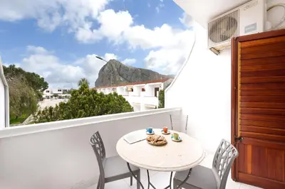 a white balcony with a table and chairs and a window at Casa Vacanze Margherita in San Vito lo Capo