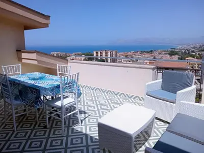 a patio with a table and chairs on a balcony at Villa Rizzo in Castellammare del Golfo