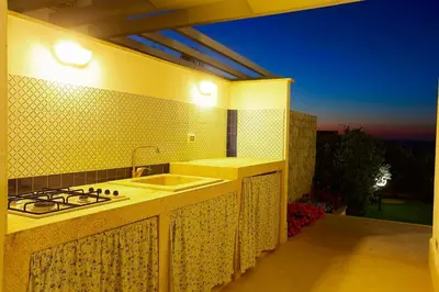 a kitchen with a sink and a stove at Villa Bianca in Alcamo
