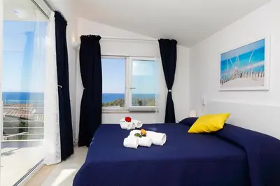 a bedroom with two stuffed animals sitting on a bed at Villa Bianca in Alcamo