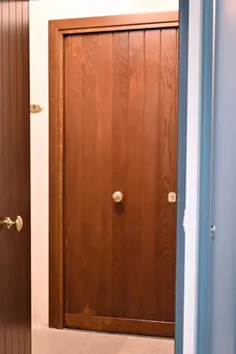 a wooden door in a room with a door at Aria di Sale centro storico in Palermo